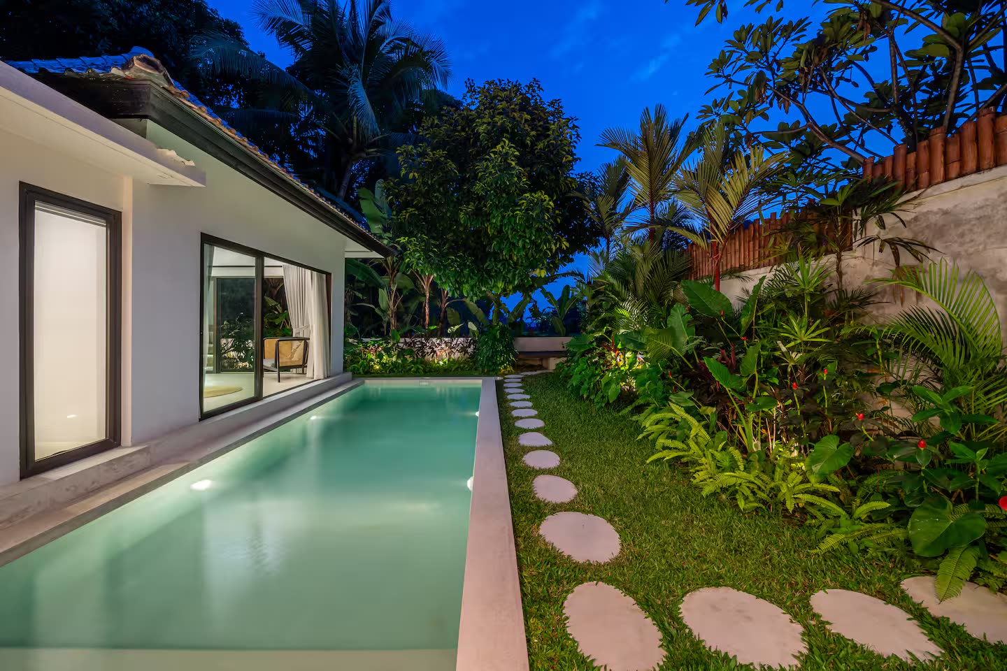Pool at blue hour with jungle backdrop